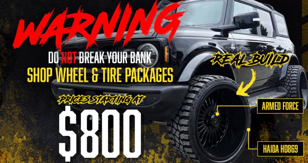 Vehicle with larger aftermarket tires installed, illustrating a tire upgrade and its potential impact on manufacturer warranty.