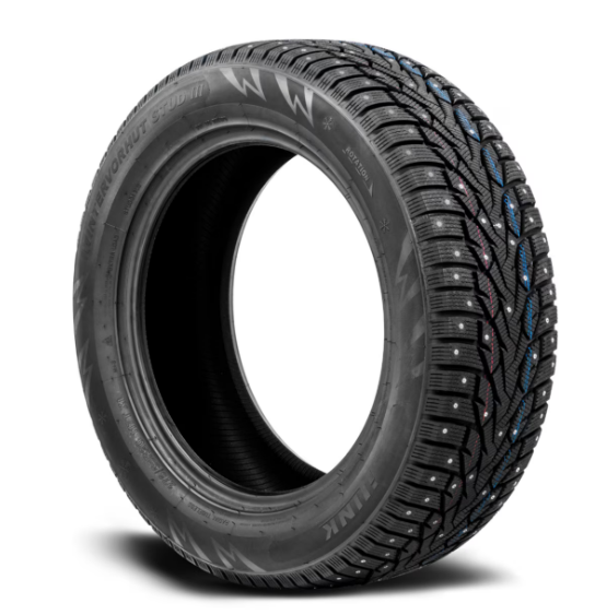 Studded winter tire with metal studs designed for traction on icy roads.